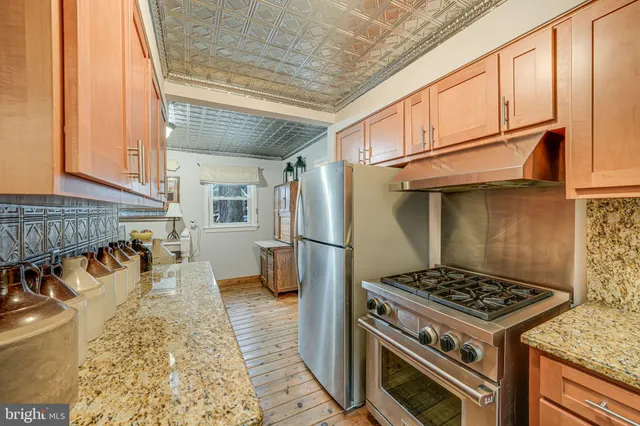 a kitchen with stainless steel appliances granite countertop a stove and a refrigerator