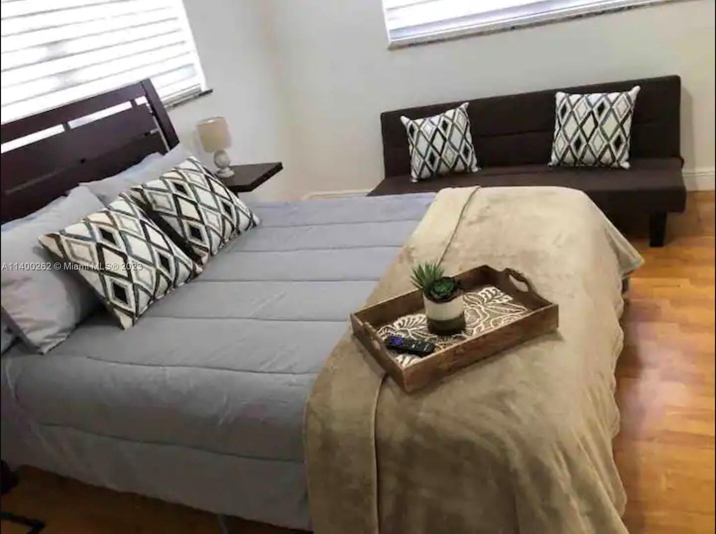 1232 Southwest 30th Place Miami, FL 33135 - Photo 4 of 7 a bedroom with a bed and wooden floor