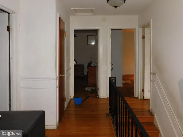 a view of a hallway with livingroom and furniture