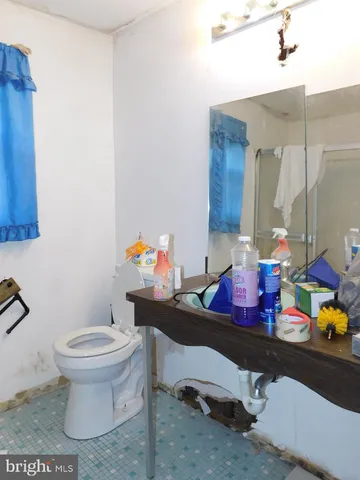 a bathroom with a sink toilet and a mirror