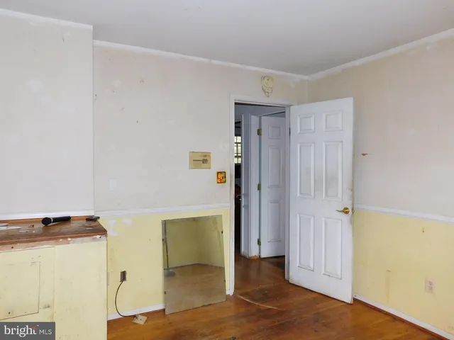 a view of a room with wooden floor and cabinet
