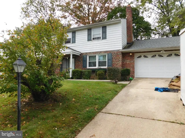 a view of a yard in front view of a house
