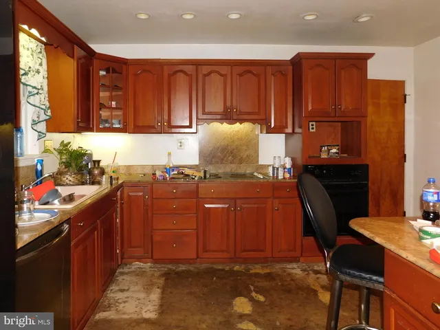 a kitchen with granite countertop wooden cabinets and a granite counter tops