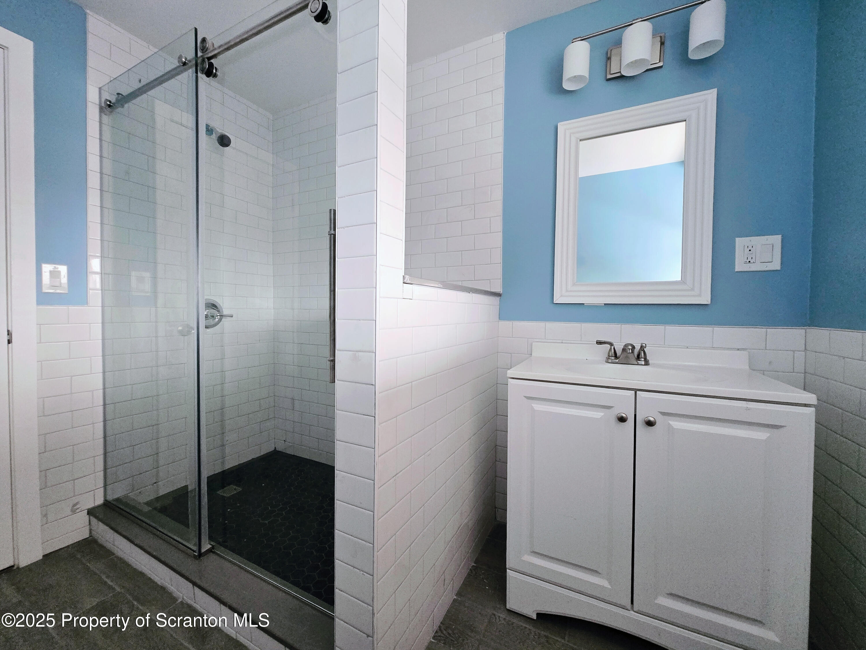 1513 Meylert Avenue Scranton, PA 18509 - Photo 14 of 27 a bathroom with a shower sink and mirror