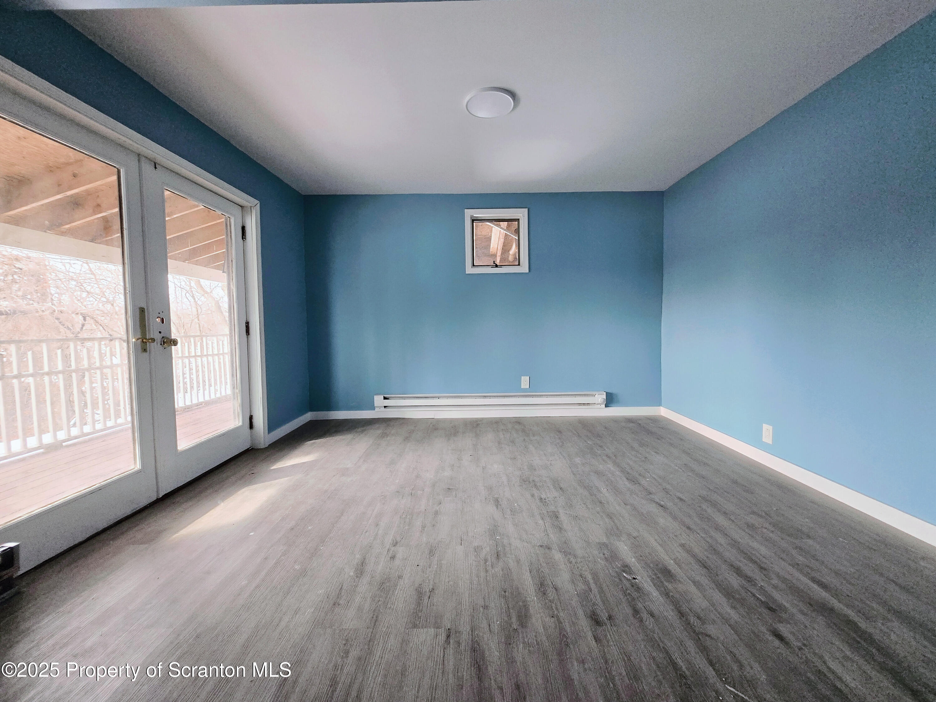 1513 Meylert Avenue Scranton, PA 18509 - Photo 15 of 27 an empty room with wooden floor and windows