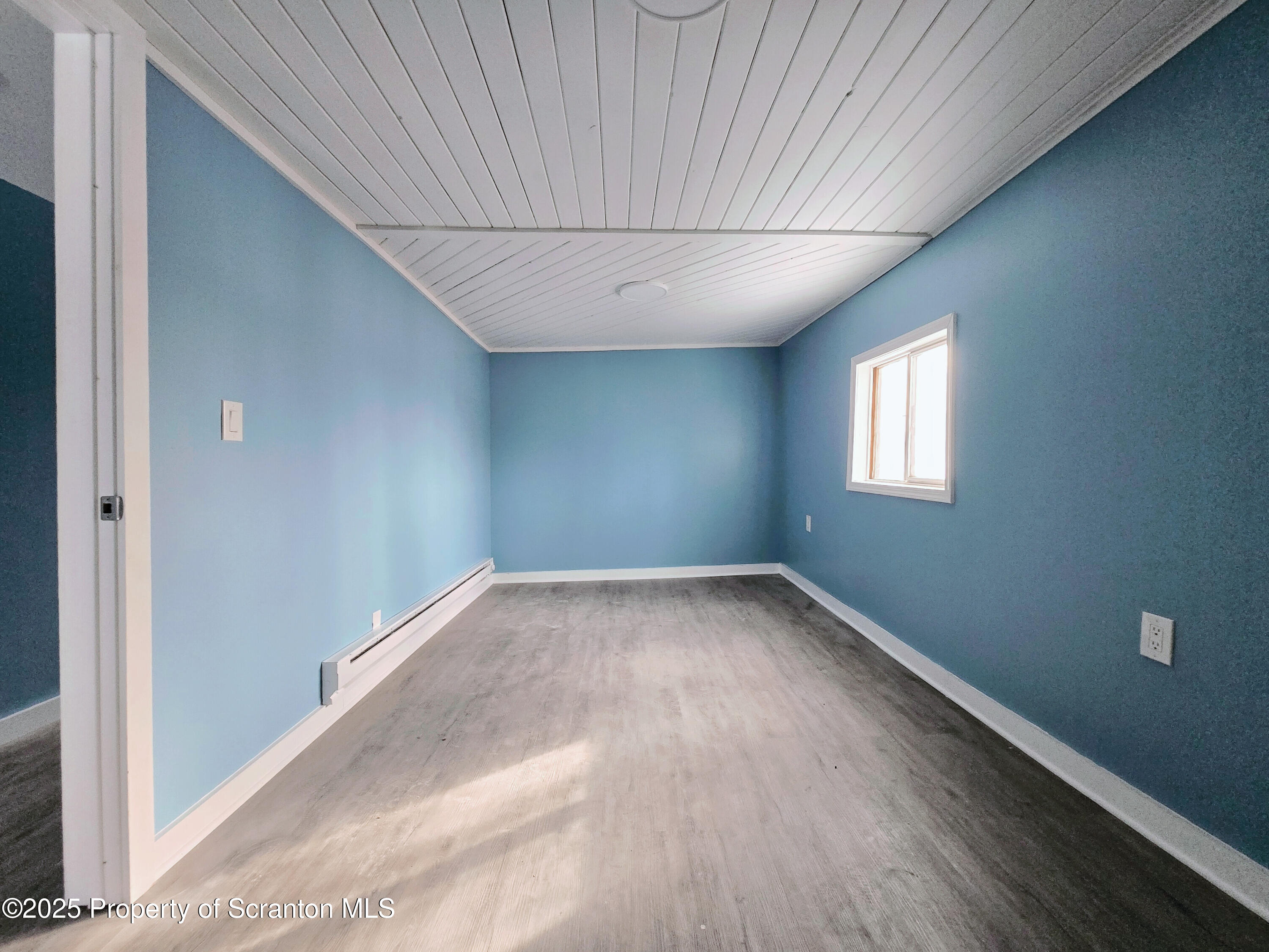 1513 Meylert Avenue Scranton, PA 18509 - Photo 19 of 27 a view of a big room with wooden floor and windows