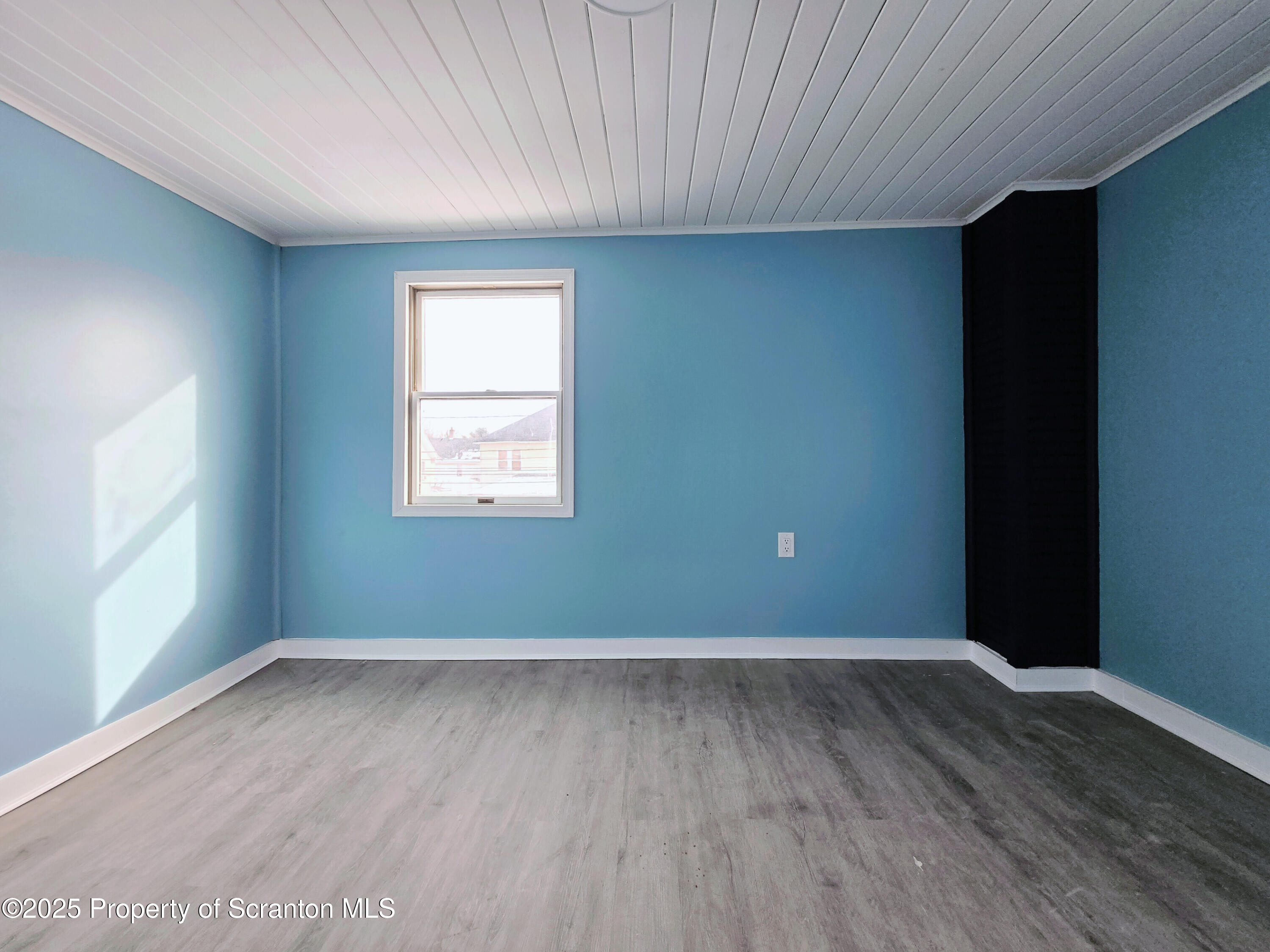 1513 Meylert Avenue Scranton, PA 18509 - Photo 21 of 27 an empty room with wooden floor and windows