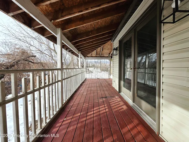 a view of balcony with wooden floor
