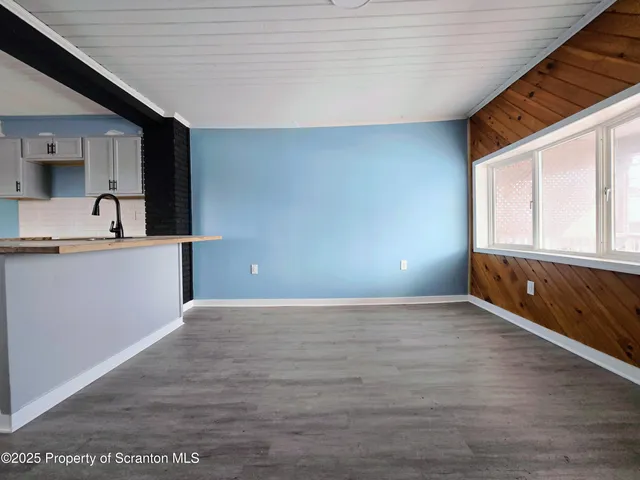 a view of a kitchen with a sink and a window