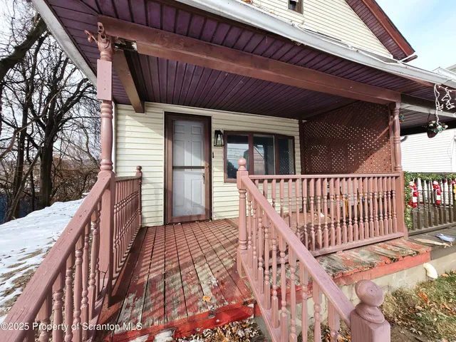 a view of balcony with wooden floor and fence
