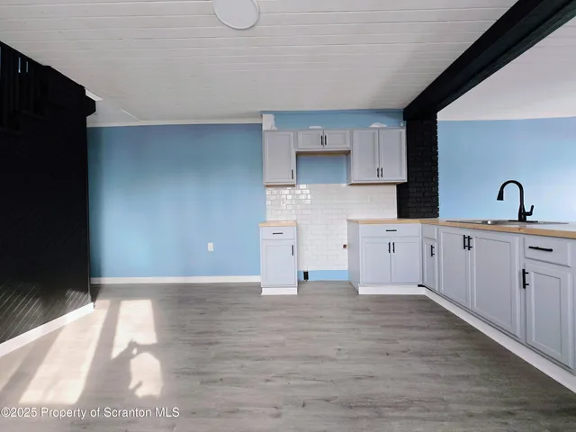 a kitchen with granite countertop a sink and a stove top oven