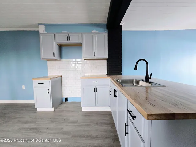 a kitchen with a sink stove and cabinets