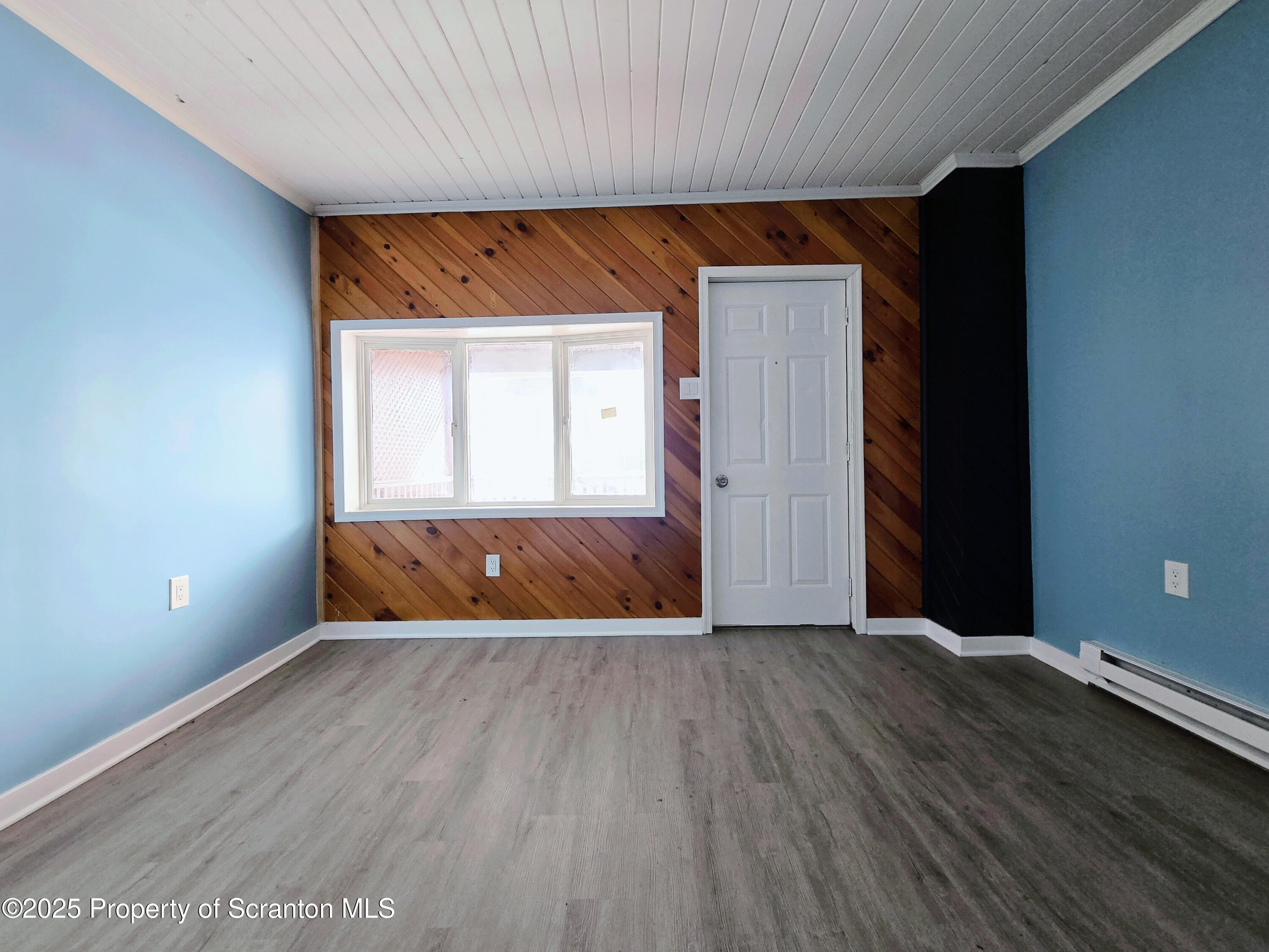 1513 Meylert Avenue Scranton, PA 18509 - Photo 8 of 27 an empty room with wooden floor and windows