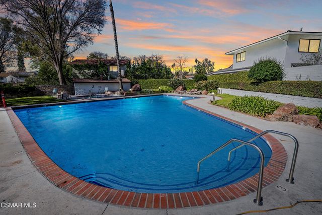 a view of swimming pool with outdoor seating and city view