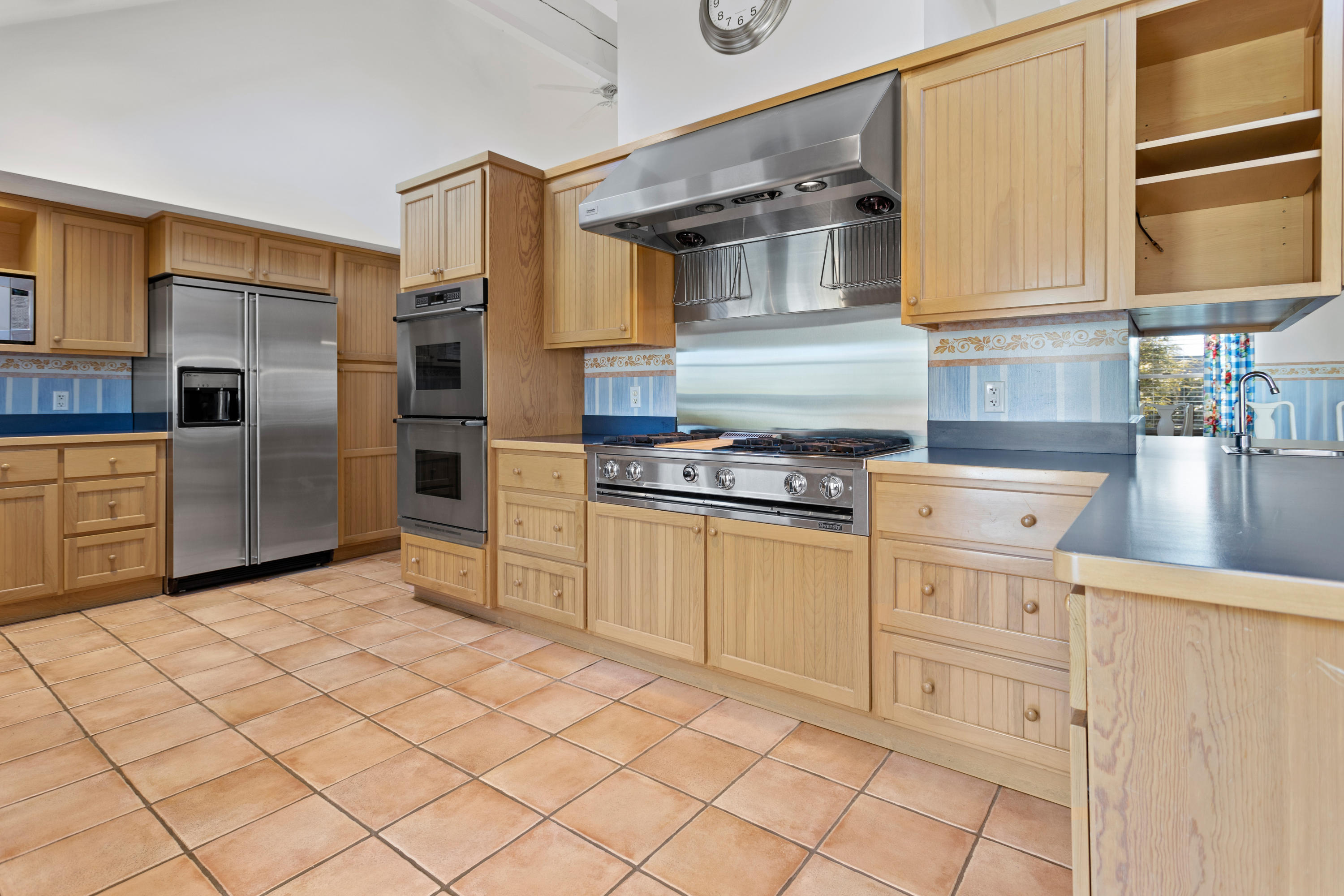 20 Long Road Harwich, MA 02645 - Photo 11 of 40 a kitchen with white cabinets and appliances