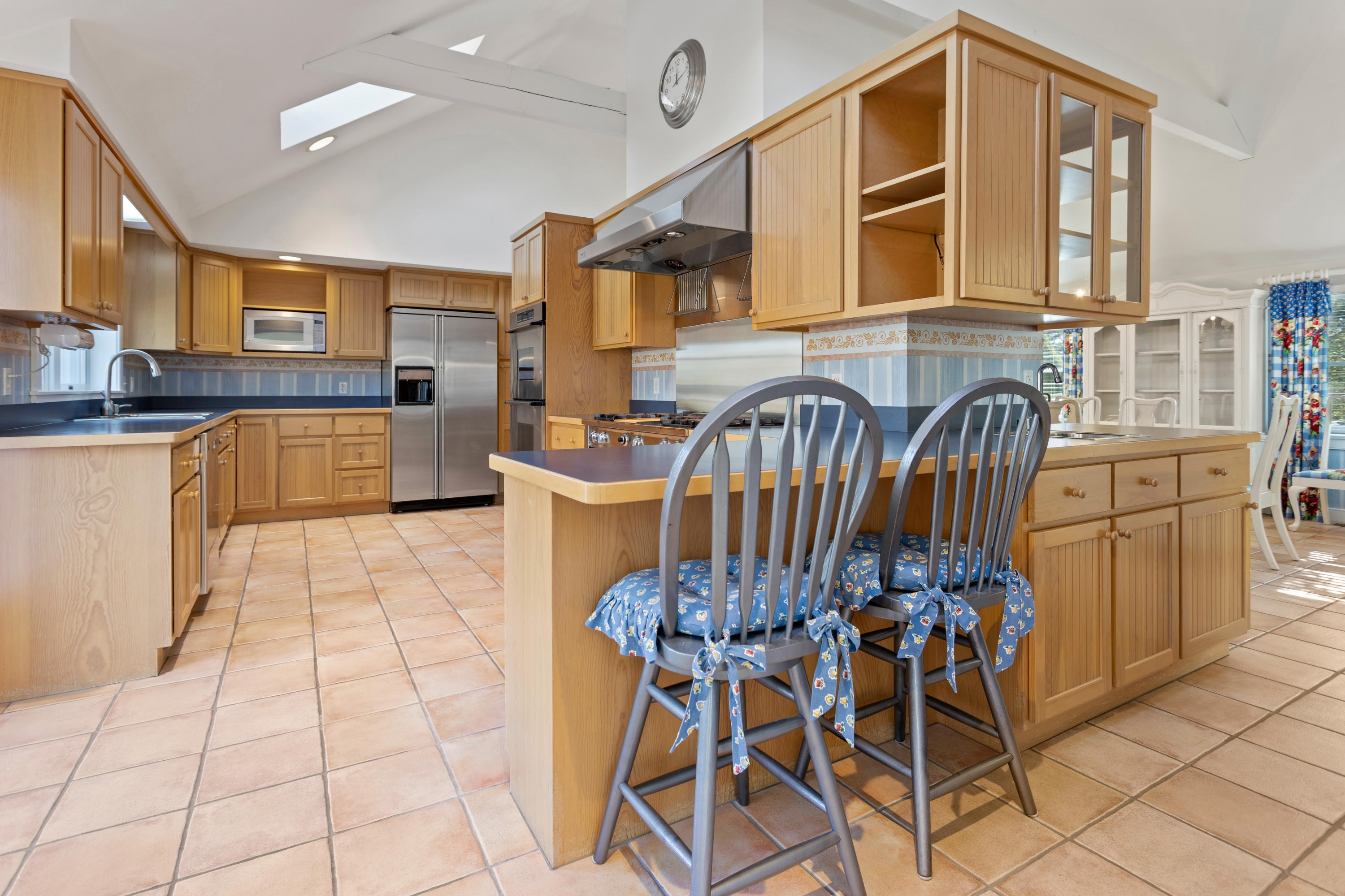 20 Long Road Harwich, MA 02645 - Photo 10 of 40 a kitchen with granite countertop a stove a sink and white cabinets with wooden floors