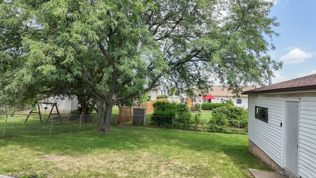 a backyard of a house with table and chairs