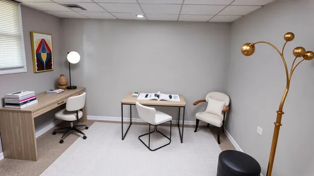 a view of a workspace with furniture and a mirror