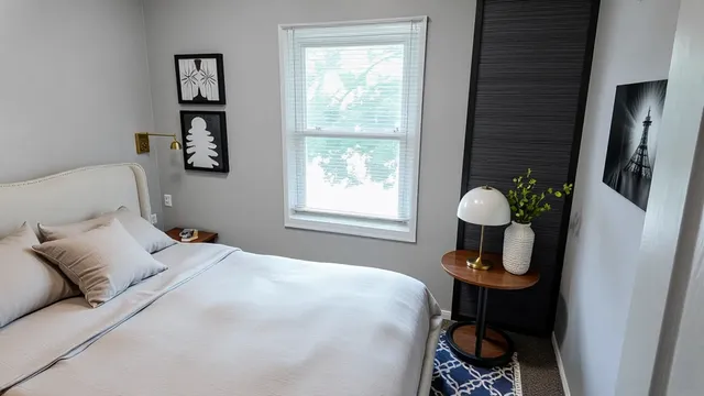 a bedroom with a bed and a window