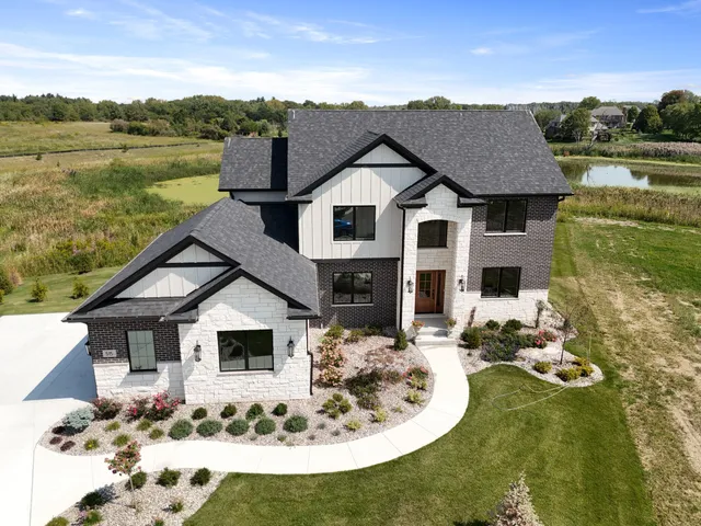 a view of a house with garden bath tub and couches and a fire pit