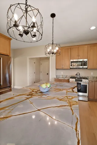 a bedroom with a bed and a dresser with mirror