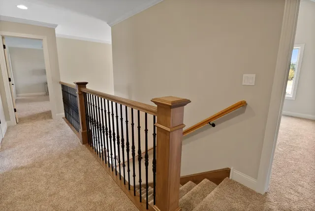 an empty room with a window and a ceiling fan