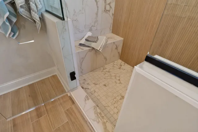 a white toilet sitting next to a white cabinet