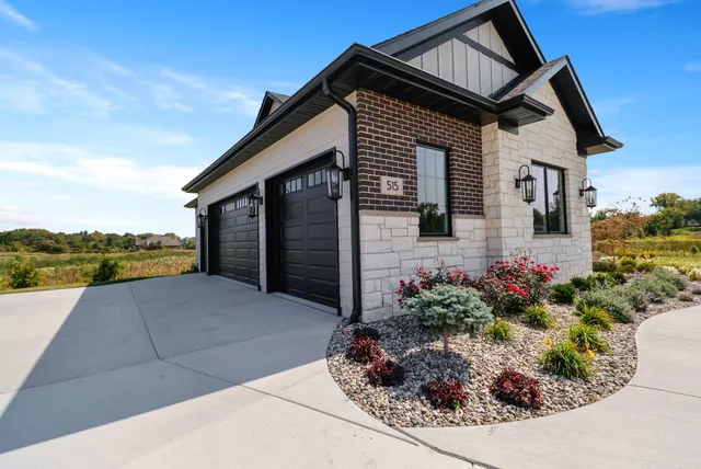 a front view of a house with a yard and flowers