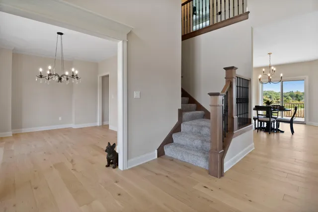 a view of a workspace room with wooden floor and windows