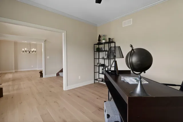 a bathroom with a granite countertop sink a refrigerator and a chandelier