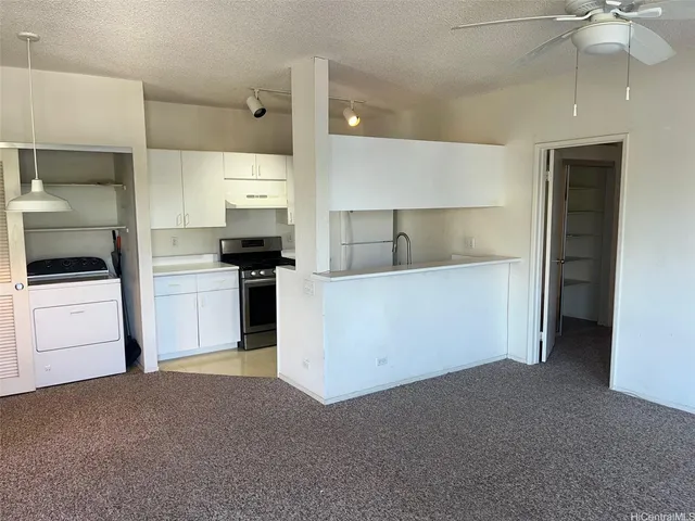 a kitchen with cabinets and white appliances