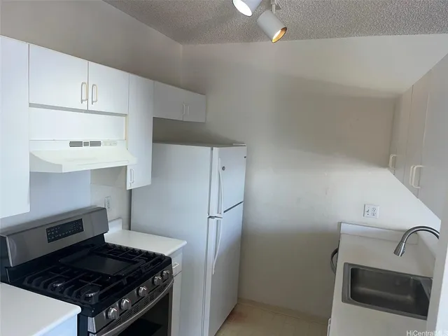 a kitchen with a stove and a refrigerator