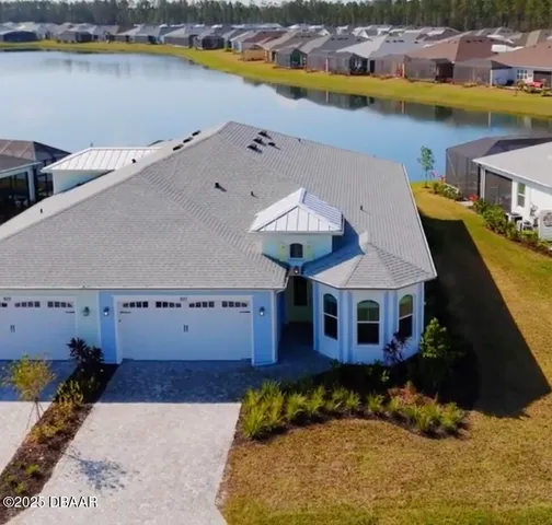 an aerial view of a house with a swimming pool