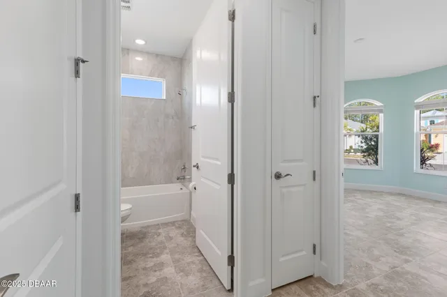 an empty room with windows and cabinet