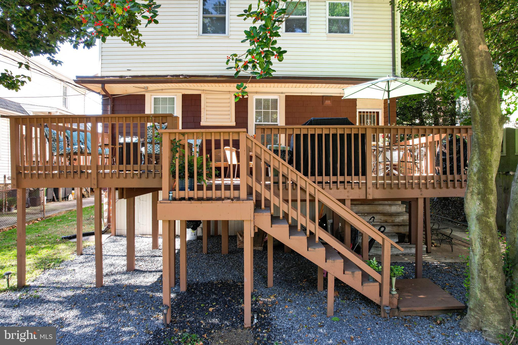 211 Mallow Hill Road Baltimore, MD 21229 - Photo 42 of 49 a view of a house with wooden deck and a yard