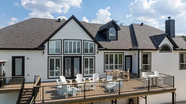a view of house with chairs and deck