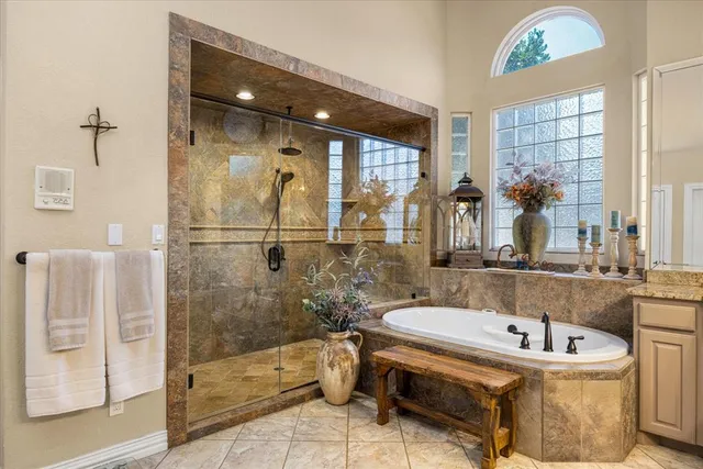 a bedroom with a bed a couch and a window