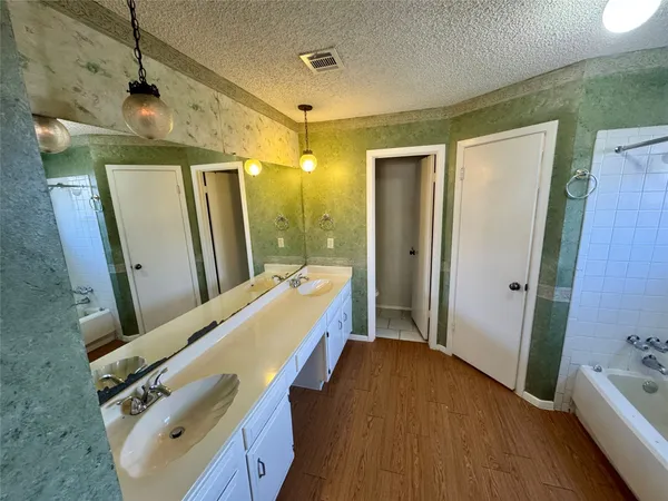 a bathroom with a double vanity sink a mirror and shower