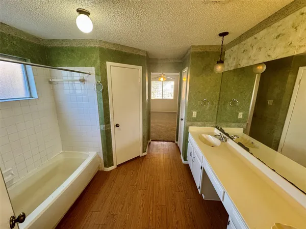 a bathroom with a tub sink and shower