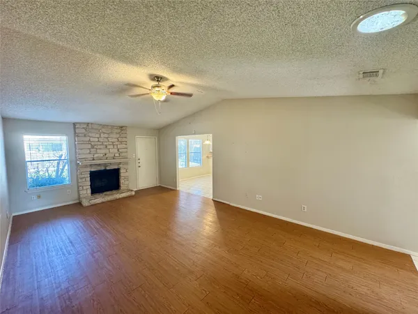 wooden floor in an empty room with a fireplace