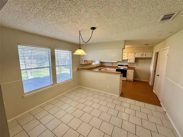 a kitchen with stainless steel appliances a refrigerator a sink a stove a microwave and cabinets