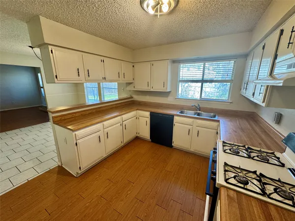 a kitchen with a stove a sink and a refrigerator