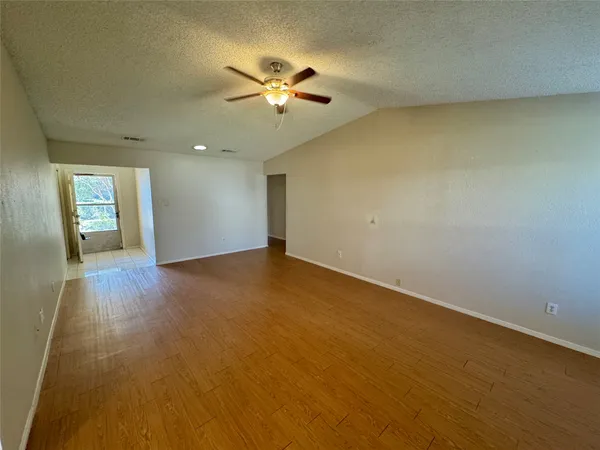 an empty room with a empty space and a ceiling fan
