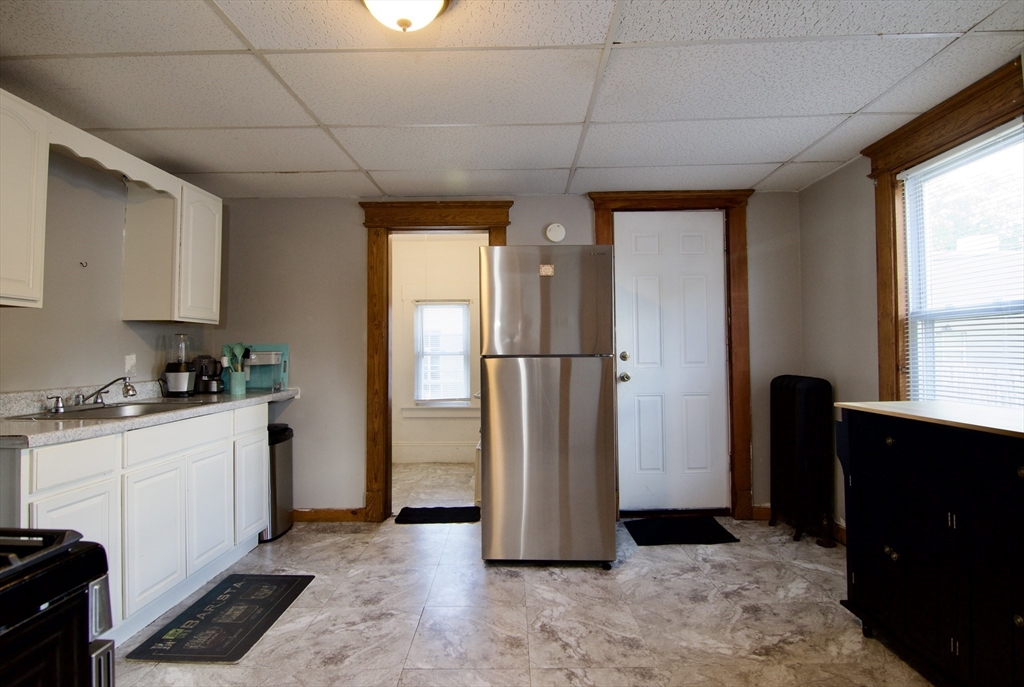 16 Amity Court Springfield, MA 01108 - Photo 18 of 42 a view of a kitchen with a refrigerator cabinets and a window