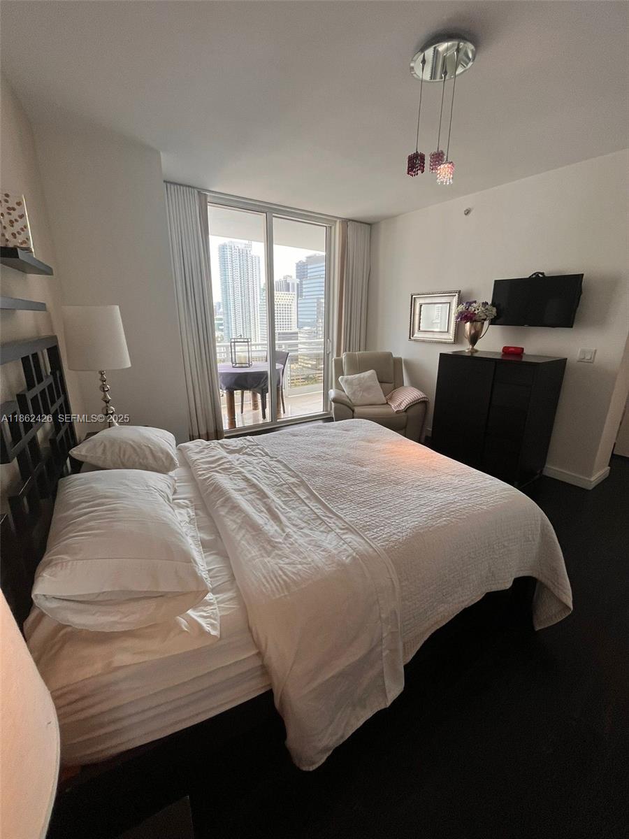 901 Brickell Key Boulevard, Unit 2701 Miami, FL 33131 - Photo 13 of 30 a bedroom with a bed and window