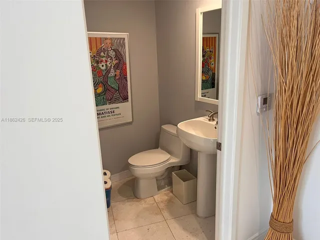 a white toilet sitting next to a bathroom sink