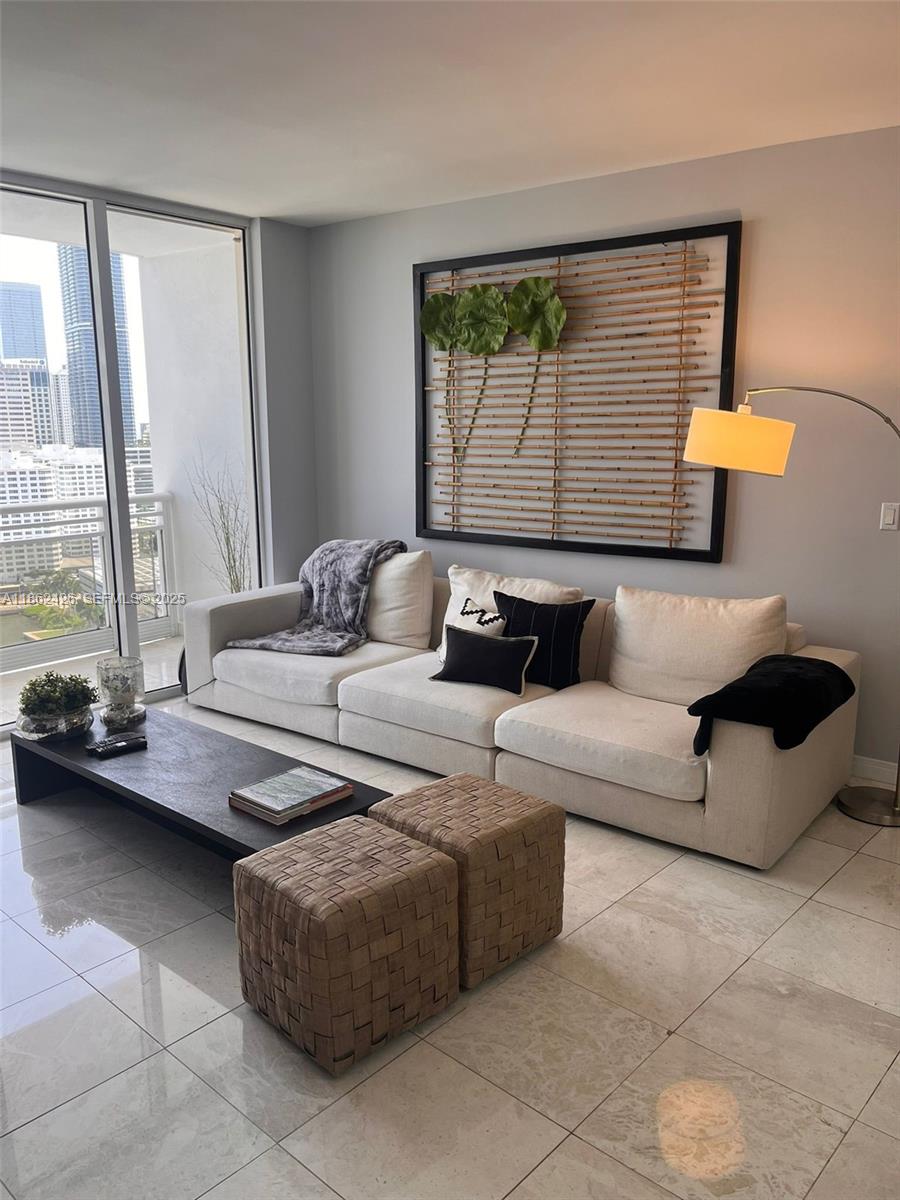 901 Brickell Key Boulevard, Unit 2701 Miami, FL 33131 - Photo 2 of 30 a living room with furniture and a window