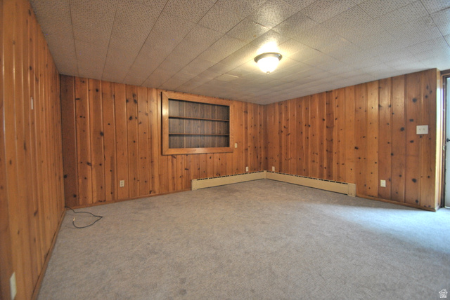 33 North 200 East Logan, UT 84321 - Photo 50 of 54 Unfurnished room with wooden walls, carpet floors, and baseboard heating