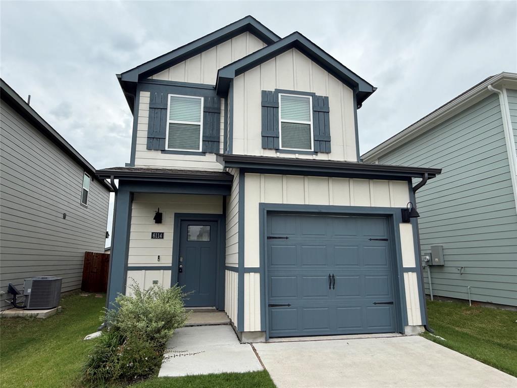 a view of house with outdoor space and garage