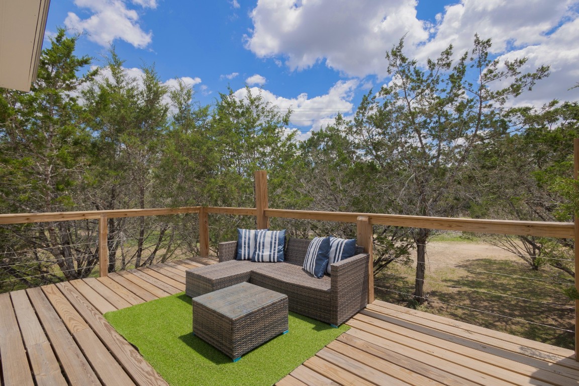 539 Rio Luna Drive Bandera, TX 78003 - Photo 16 of 24 a view of balcony with couches and wooden floor